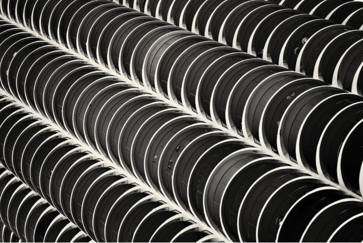 Black and white photo of an apartment building that focuses on the circular shape of each floor.