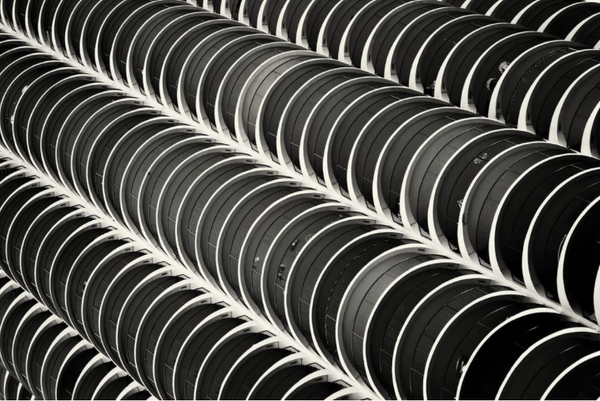 Black and white photo of an apartment building that focuses on the circular shape of each floor.